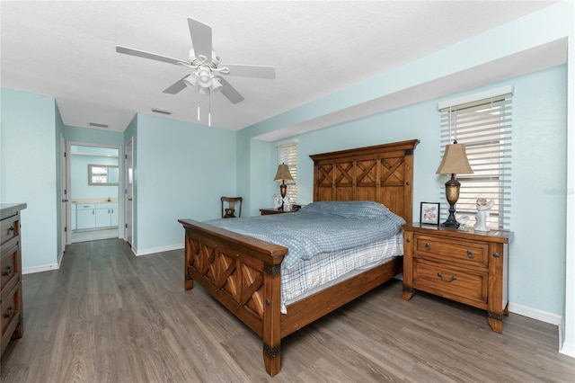 bedroom with ceiling fan, hardwood / wood-style floors, and a textured ceiling