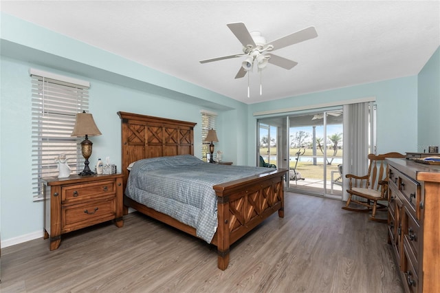 bedroom featuring hardwood / wood-style floors, access to outside, and ceiling fan