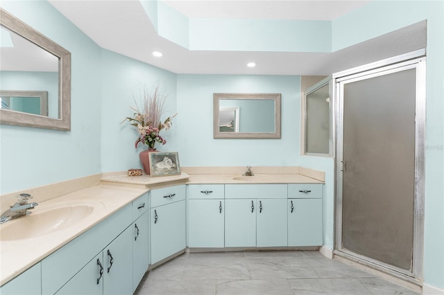 bathroom featuring vanity and a shower with door