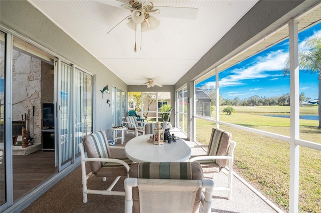 sunroom featuring ceiling fan