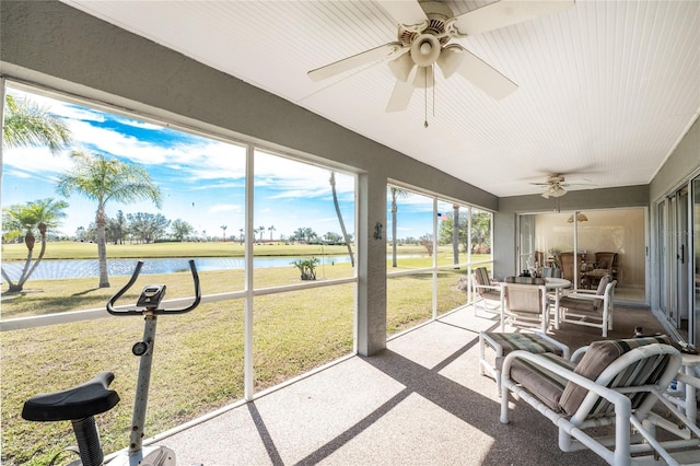 sunroom / solarium with a water view and ceiling fan