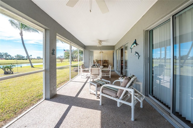 sunroom featuring ceiling fan