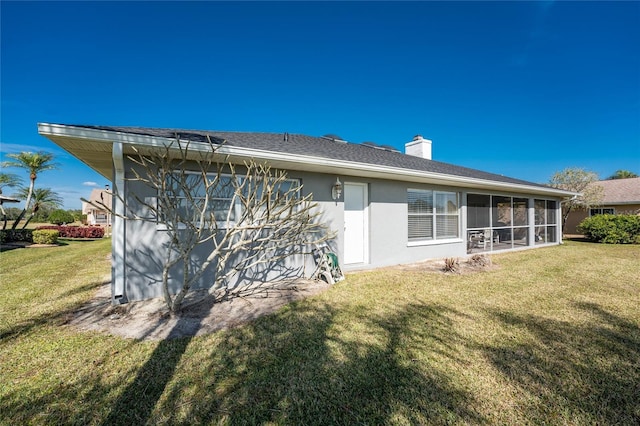 back of house with a lawn