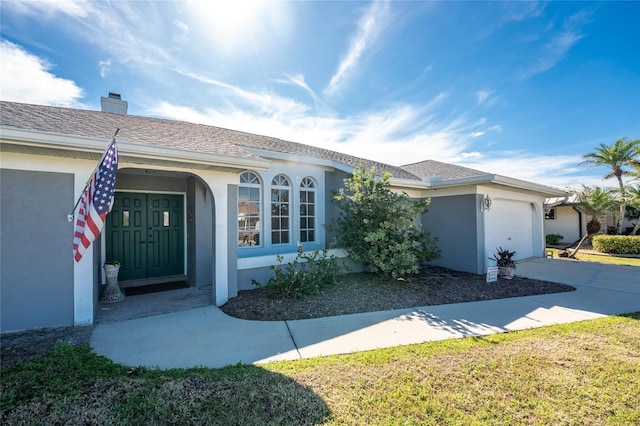 view of front of home with a garage and a front yard