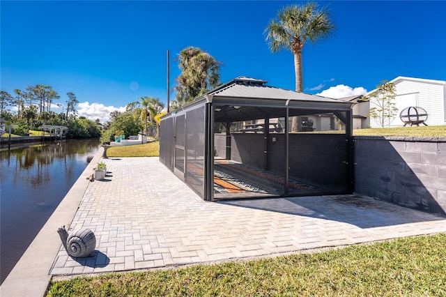 view of patio / terrace with a gazebo and a water view