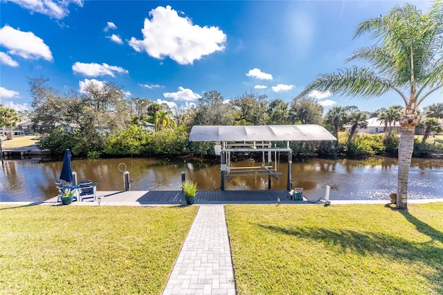 view of dock featuring a water view, a yard, and boat lift