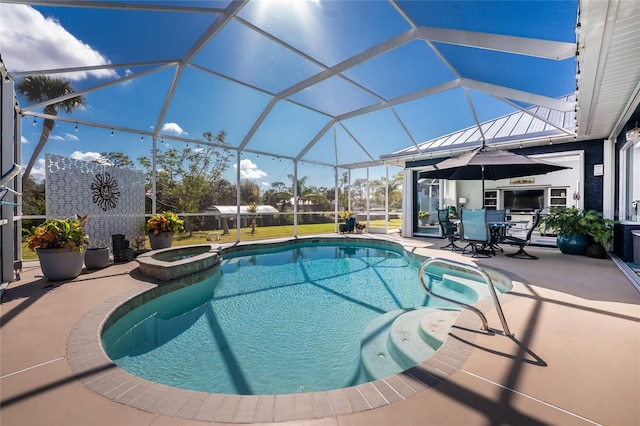 view of pool featuring a patio area, glass enclosure, and a pool with connected hot tub