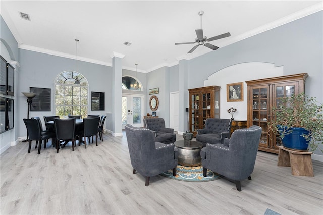 living area featuring ornamental molding, french doors, visible vents, and light wood finished floors