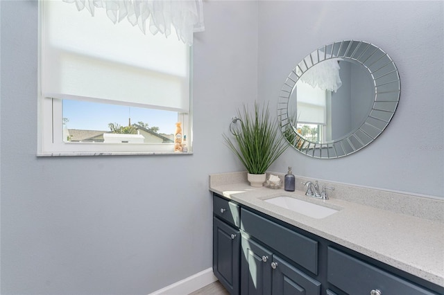 bathroom featuring baseboards and vanity