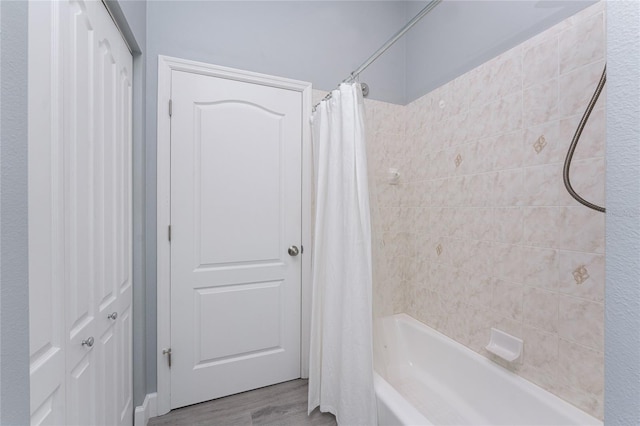 bathroom with wood finished floors and shower / bath combination with curtain