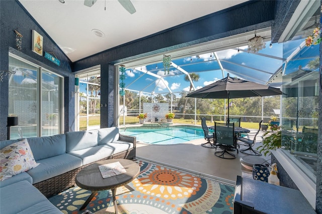 sunroom featuring a pool and a ceiling fan