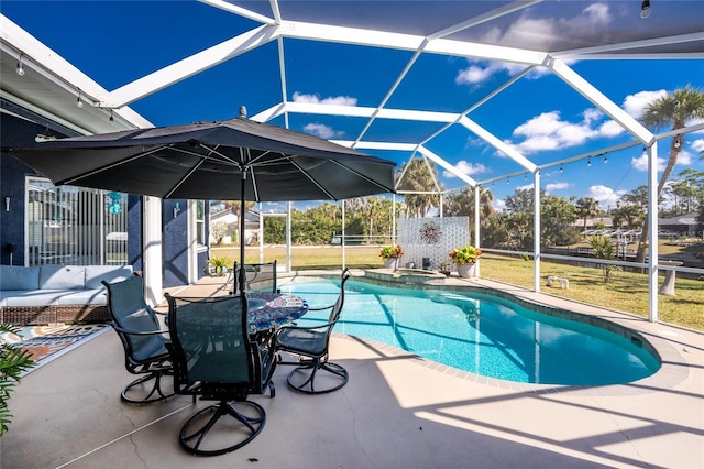 view of pool featuring a lanai, a patio area, and a pool with connected hot tub