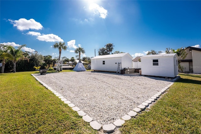 back of property with an outbuilding and a lawn