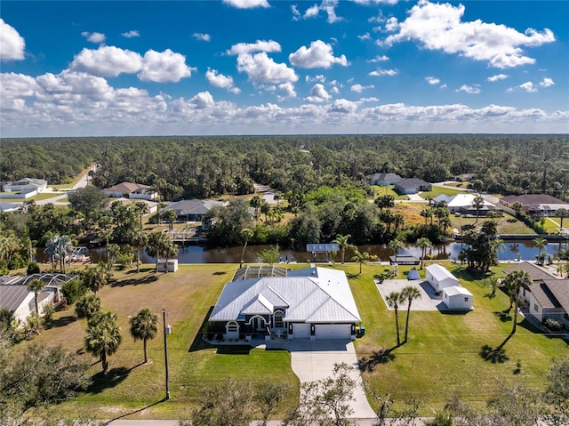 birds eye view of property featuring a residential view, a water view, and a forest view