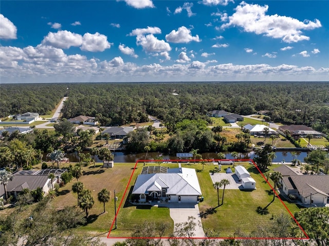 bird's eye view with a water view, a wooded view, and a residential view