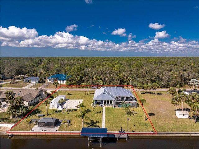 birds eye view of property featuring a water view and a forest view