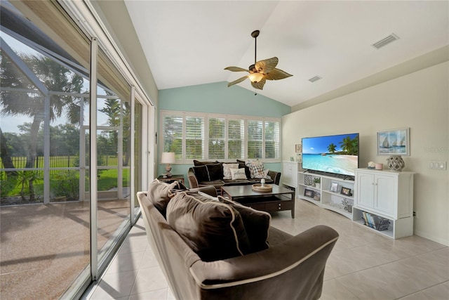 tiled living room with ceiling fan and vaulted ceiling