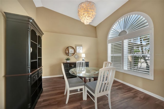 dining area featuring vaulted ceiling, dark wood-type flooring, and a chandelier