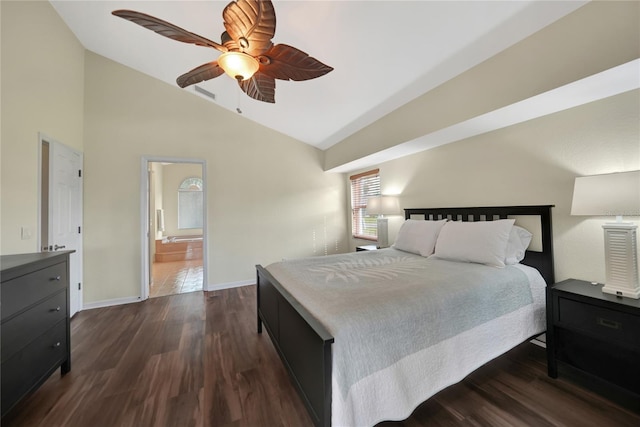 bedroom with vaulted ceiling, ceiling fan, dark hardwood / wood-style flooring, and ensuite bath