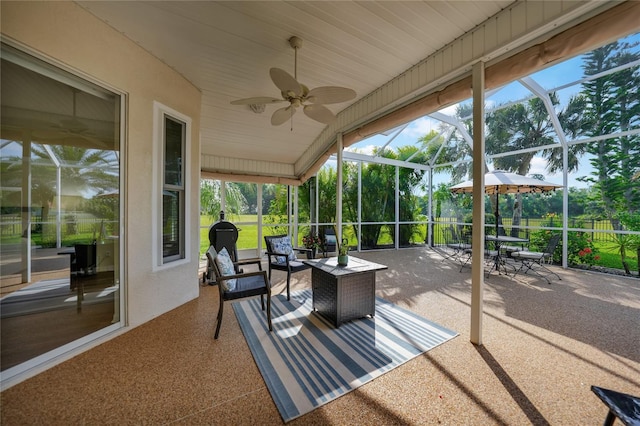 sunroom featuring ceiling fan