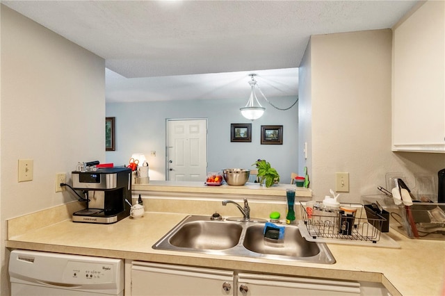 kitchen with white cabinetry, sink, hanging light fixtures, and dishwasher