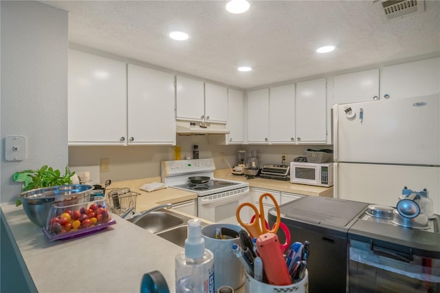 kitchen with white cabinetry, white appliances, and a textured ceiling