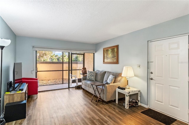 living room with hardwood / wood-style flooring and a textured ceiling