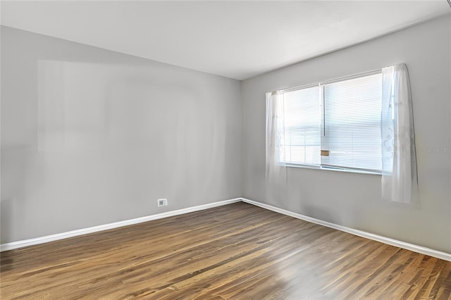 unfurnished room featuring dark hardwood / wood-style flooring