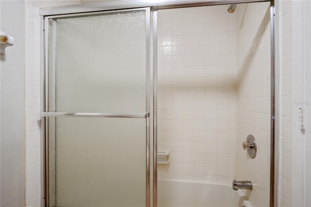 bathroom featuring bath / shower combo with glass door