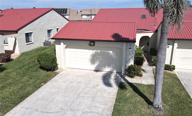 view of front of house featuring a garage, a front yard, and central AC unit