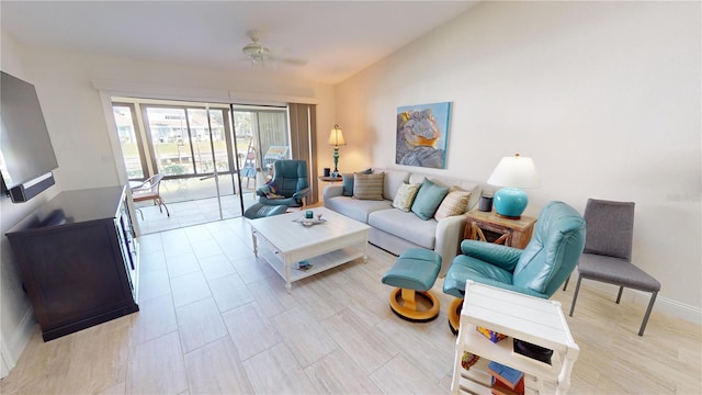 living room with ceiling fan and vaulted ceiling