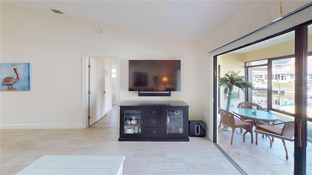 tiled living room with vaulted ceiling