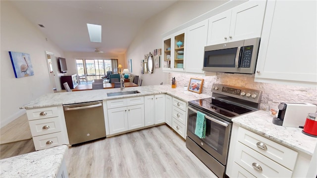 kitchen featuring appliances with stainless steel finishes, white cabinets, and kitchen peninsula