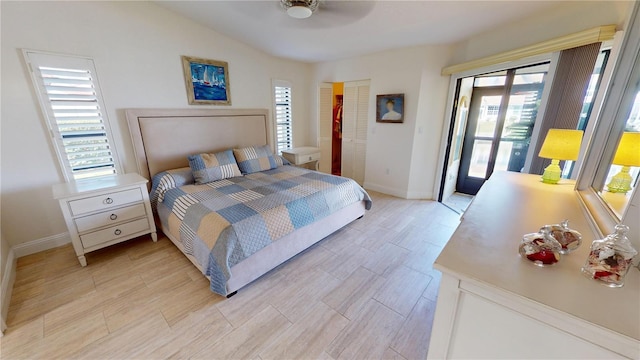 bedroom with lofted ceiling and access to outside