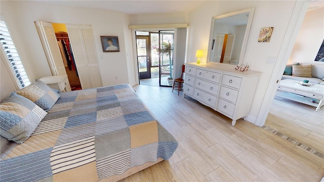 bedroom with a closet, access to outside, and light hardwood / wood-style flooring