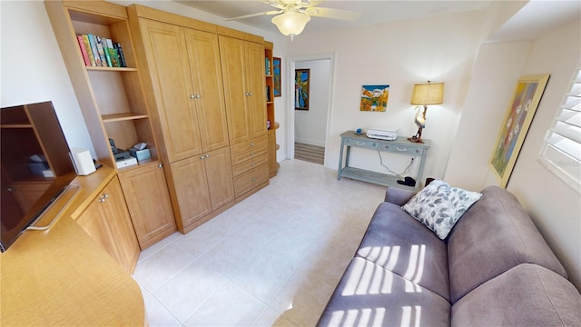 tiled living room with built in shelves and ceiling fan