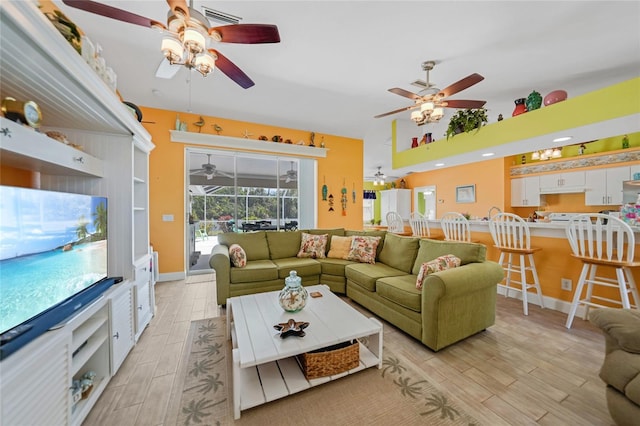 living room with ceiling fan and light hardwood / wood-style floors