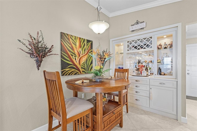 dining space featuring crown molding, bar, and light tile patterned floors