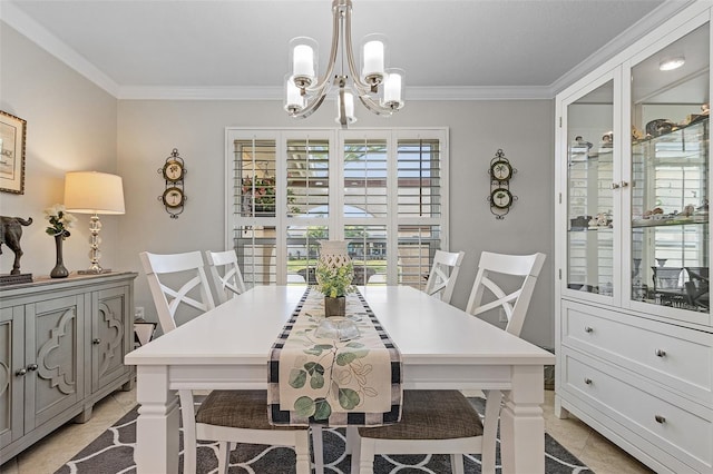 dining space with ornamental molding and a chandelier