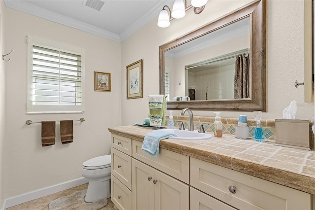 bathroom with crown molding, vanity, and toilet