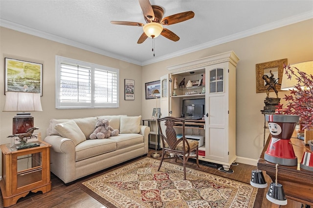 living room featuring ornamental molding, dark wood-type flooring, and ceiling fan