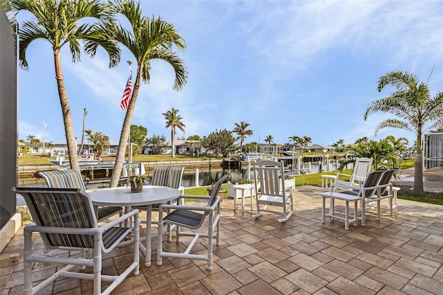 view of patio / terrace with a water view and a dock