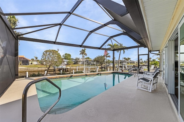 view of pool with a patio area and glass enclosure