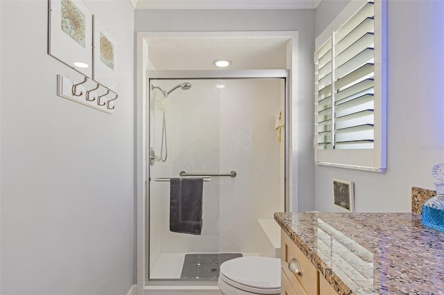 bathroom featuring vanity, ornamental molding, toilet, and walk in shower