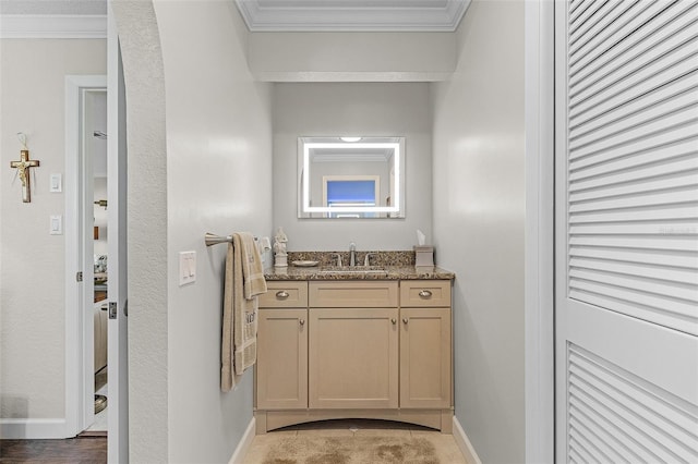 bathroom featuring ornamental molding and vanity