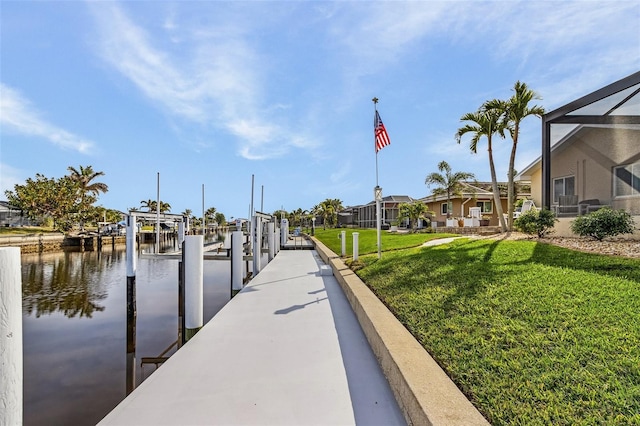 dock area featuring a water view, glass enclosure, and a lawn