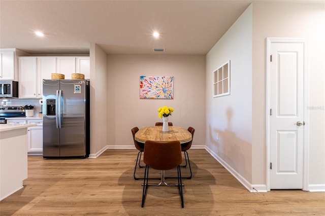 dining room with light hardwood / wood-style floors