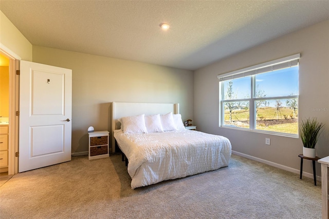 carpeted bedroom featuring a textured ceiling