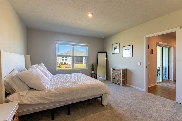 carpeted bedroom with a textured ceiling