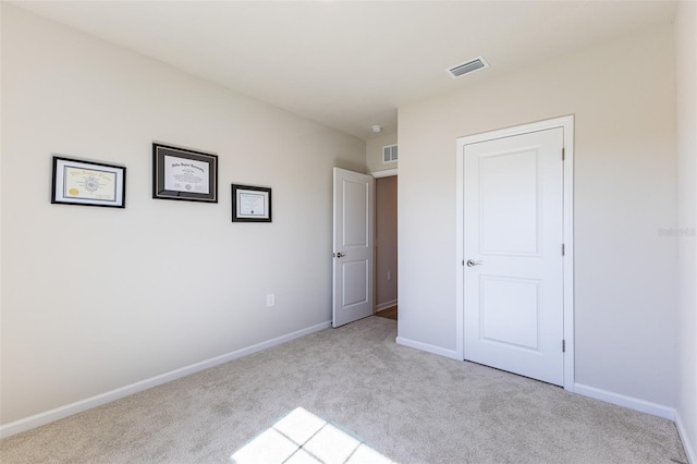 unfurnished bedroom with light carpet